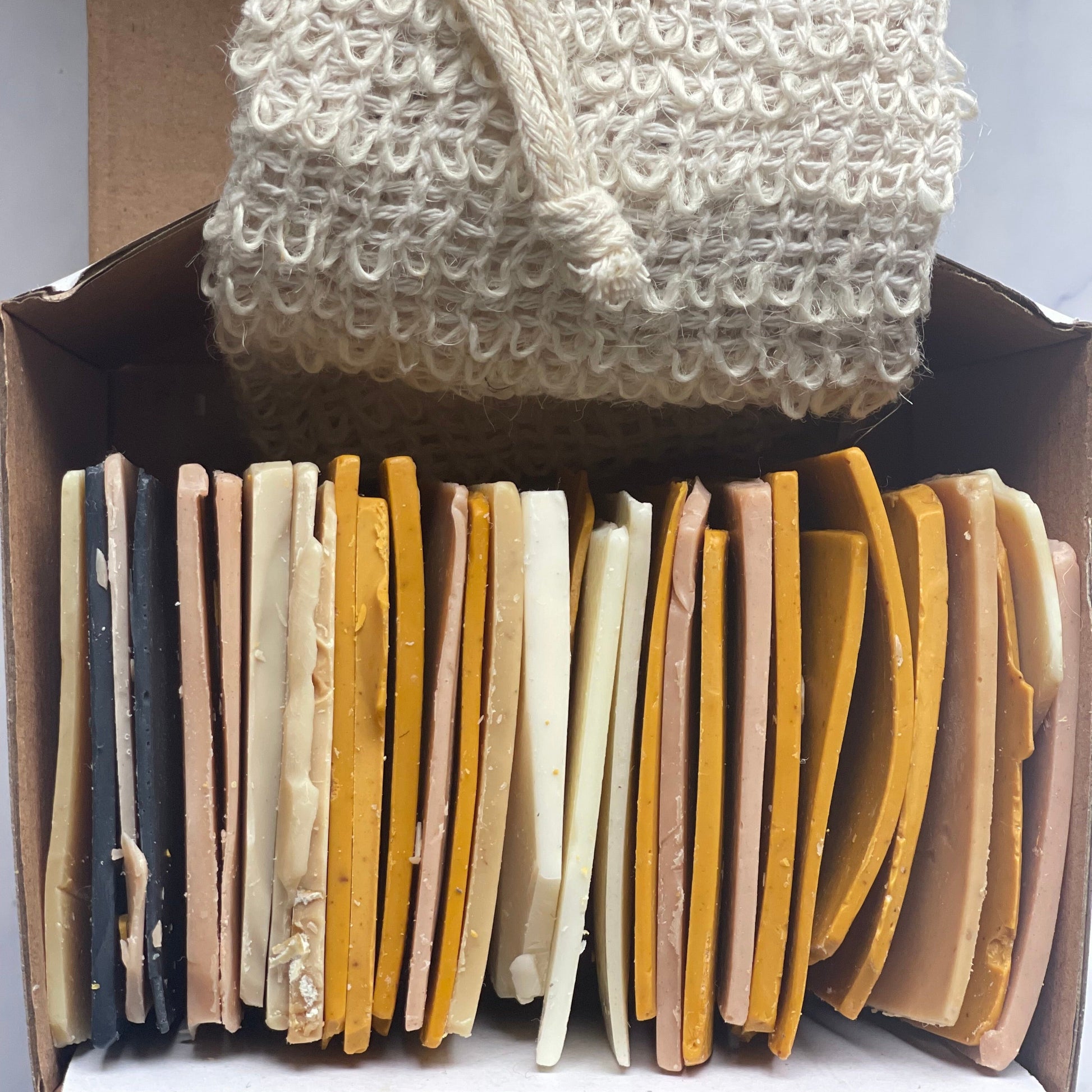 500g soap offcuts in box and soap exfoliating bag, top view